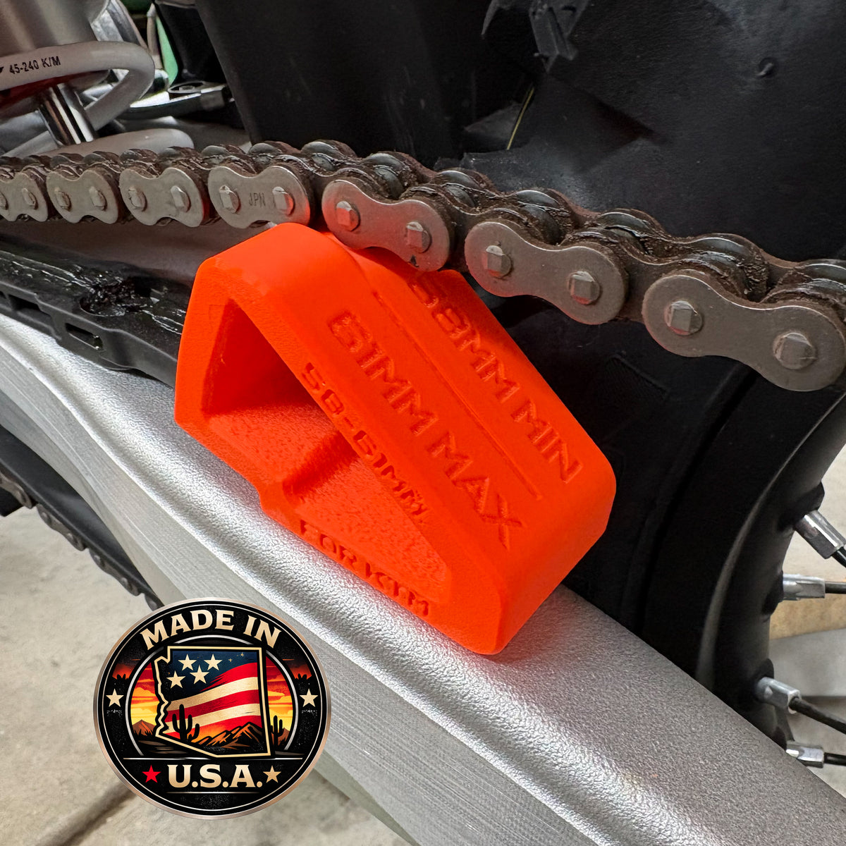 SlackSpec chain slack gauge on a motocross swingarm